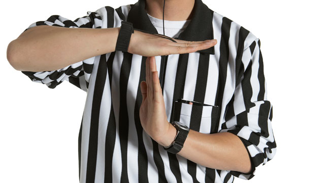 Referee making time out sign